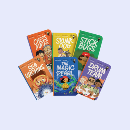 Collection of children's decodable books with colorful covers on a light blue background